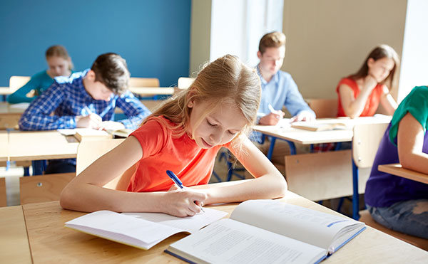 students-writing-in-classroom-open-book-exam